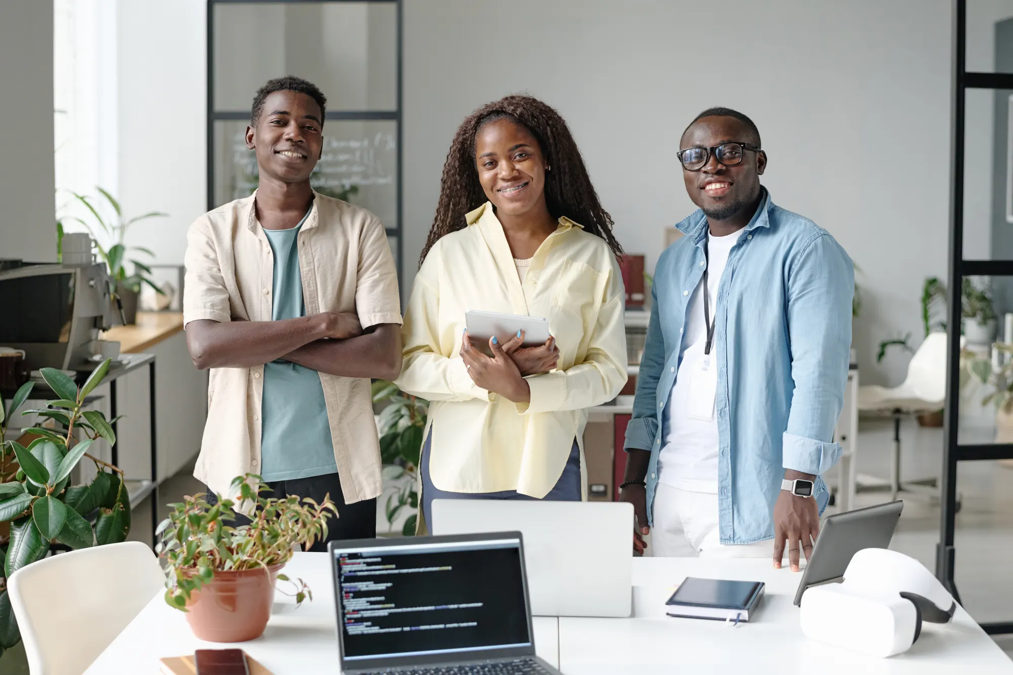 A team of colleagues standing together in a bright office