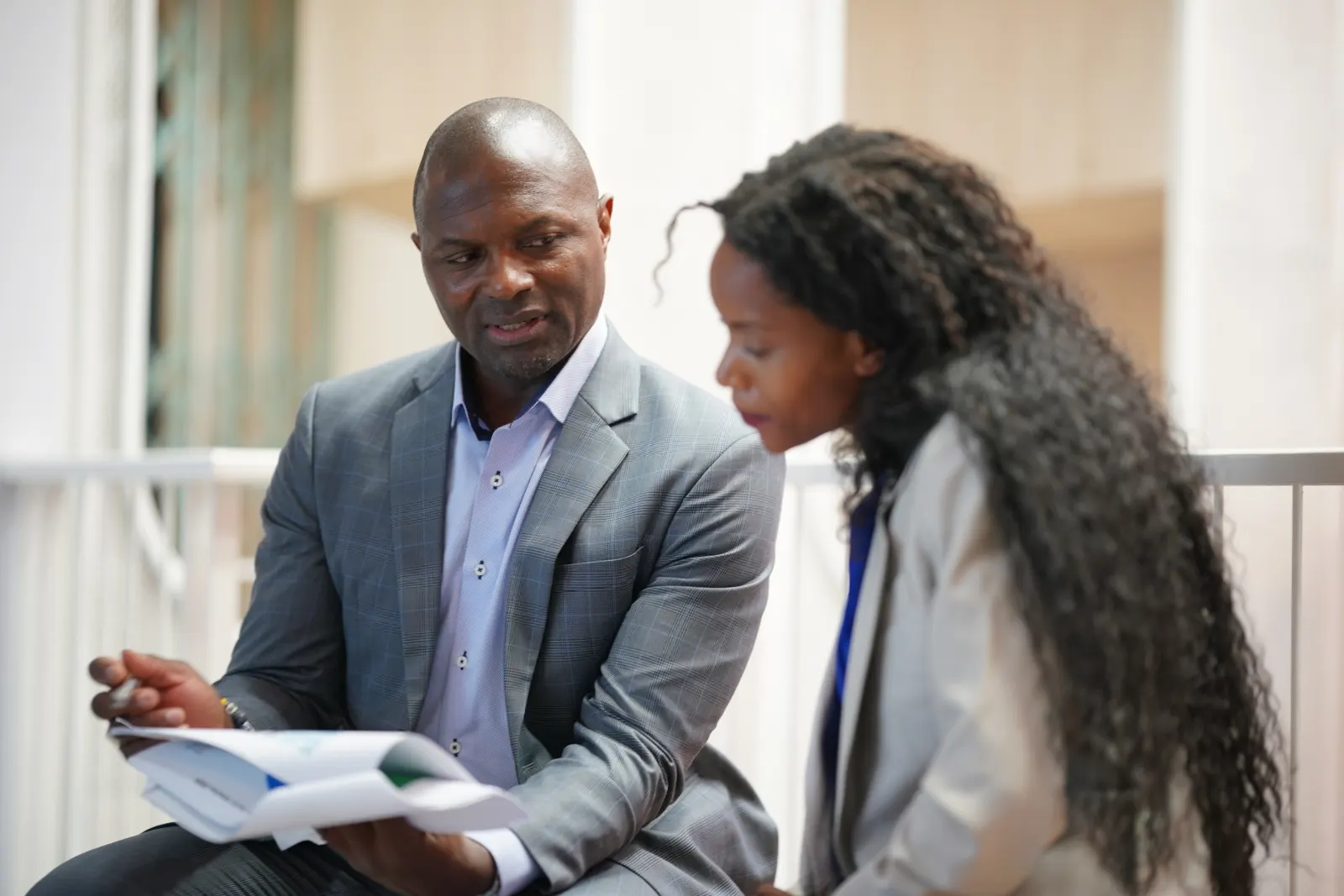 An adviser talking a client through charts and figures
